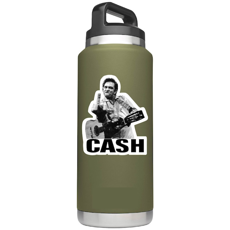 May include: A green insulated water bottle with a black lid and handle. A sticker of Johnny Cash giving the middle finger while playing a guitar is on the bottle. The sticker also has the word "CASH" in black letters.