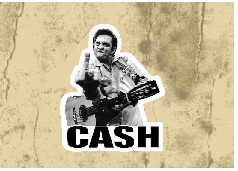 May include: Black and white photo of Johnny Cash holding a guitar and giving the middle finger. The word "CASH" is written in bold black letters below the image.