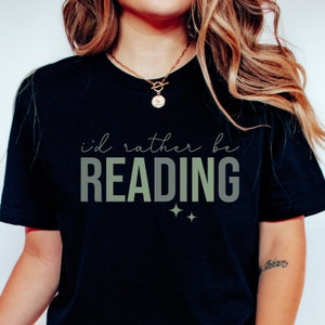 May include: Black t-shirt with the text "i'd rather be READING" in green and white lettering with two small stars below the text.