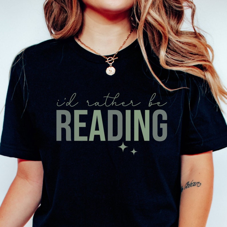 May include: Black t-shirt with the text "i'd rather be READING" in green and white lettering with two small stars below the text.