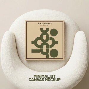 May include: A square canvas art print with a wooden frame, featuring a minimalist design in olive green on a beige background. The print displays the word "BAUHAUS" and the dates "JULY - SEPT 1923". The words "MINIMALIST CANVAS MOCKUP" are at the bottom.