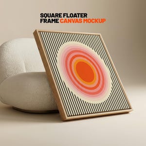 May include: Square floater frame canvas mockup. A square canvas print with a wooden frame. The artwork features an oval design with concentric circles in shades of orange and pink, set against a background of black vertical lines.