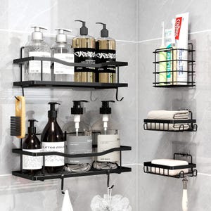 May include: Black metal shower shelves and organizers. The set includes two shelves with hooks, a toothbrush holder, a towel rack, and a soap dish. The shelves hold various bottles of shampoo, conditioner, and body wash. A brush and a loofah hang from the hooks.