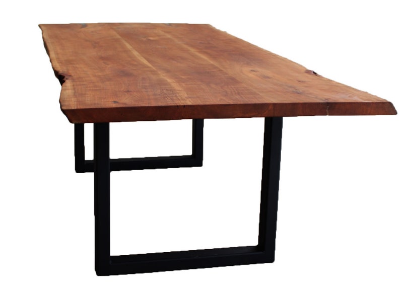 May include: A long, wooden table with a live edge top and black metal legs. The table is made of natural wood with a rich brown color.