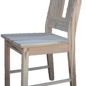 May include: A wooden chair with a simple design. The chair has a rectangular seat and a tall back with a cutout. The chair is made of light-coloured wood and has a natural finish.