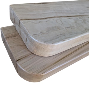 May include: Two wooden shelves with rounded edges. The shelves are made of light wood with a natural grain pattern.