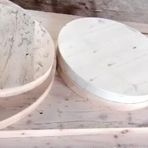 May include: Four unfinished wooden round platters of varying sizes. The platters are made of light-colored wood and have a smooth, polished surface.