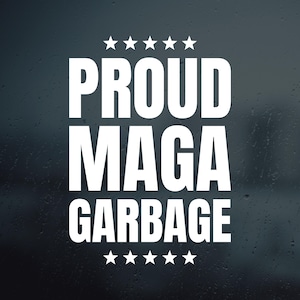 May include: White text on a dark background reads "PROUD MAGA GARBAGE" with five stars above and below the text. The background has a subtle, textured appearance.