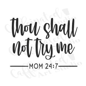 May include: Black text on a white background reads "thou shall not try me" with "MOM 24:7" below. The text is in a handwritten style, with a line separating the main text from the bottom text.