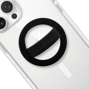 May include: A black phone grip with the word "CRYSTAL" printed on the strap. The grip is attached to a clear phone case, with the phone's camera visible in the upper left corner. The phone case has a white Apple logo.