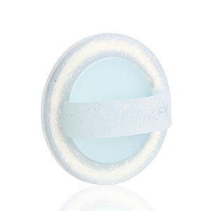 May include: A light blue and white oval-shaped beauty tool with the text "CRYSTALFY" on a white strap. The tool has a glittery, translucent outer ring and a light blue center.