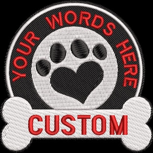 May include: White and black embroidered patch with a paw print and heart in the center. The text "YOUR WORDS HERE" is in a circle around the paw print and heart. The text "CUSTOM" is on a white bone shape below the circle.