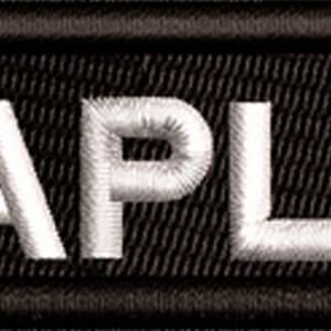 May include: Black embroidered patch with white lettering that reads "CHAPLAIN".