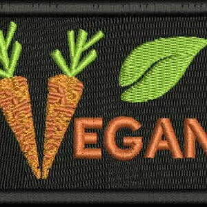 May include: A black embroidered patch with two orange carrots, a green leaf, and the word "VEGAN" in orange.