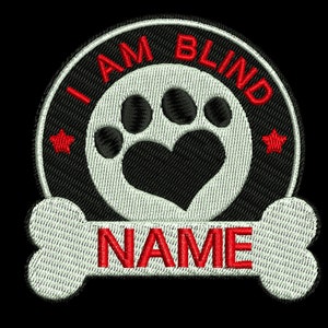 May include: Black and white embroidered patch with a paw print and heart in the center. The text "I AM BLIND" is in red around the paw print. A white bone with the text "NAME" in red is below the circle.