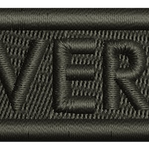 May include: A black embroidered patch with the word "MAVERICK" in white stitching.