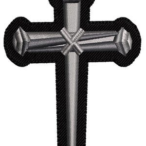 May include: A black and silver embroidered patch of a cross with nails. The cross is outlined in black and the nails are silver.