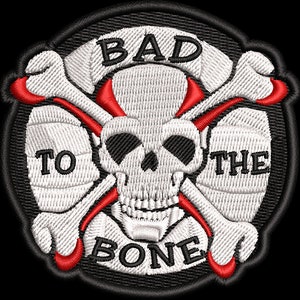 May include: A black and white embroidered patch with a skull and crossbones. The skull has red horns and the text "BAD TO THE BONE" is written around it.