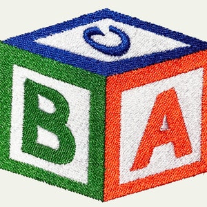 May include: A colorful embroidered block with the letters 'B', 'A', and 'C' on each side. The block is green, orange, blue, and white.