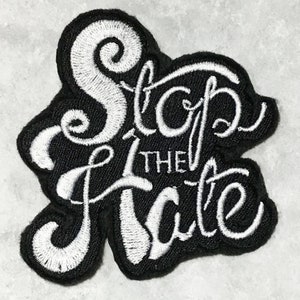 May include: Black embroidered patch with white lettering that reads "Stop the Hate".