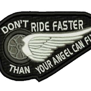 May include: Black and white embroidered patch with a motorcycle wheel and angel wings. The text reads "Don't ride faster than your angel can fly."