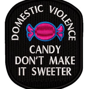 May include: Black embroidered patch with the words "DOMESTIC VIOLENCE" arched at the top and "CANDY DON'T MAKE IT SWEETER" at the bottom. A pink candy with blue outlines is in the center.