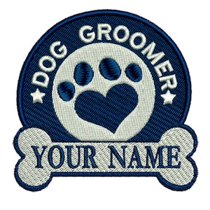 May include: Blue and white embroidered patch with a paw print and heart design. The text "Dog Groomer" is written in a circle around the paw print. The text "Your Name" is written on a bone shape below the circle.