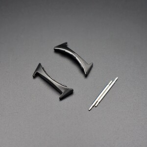 May include: Two black watch strap spring bars and three silver spring bars.
