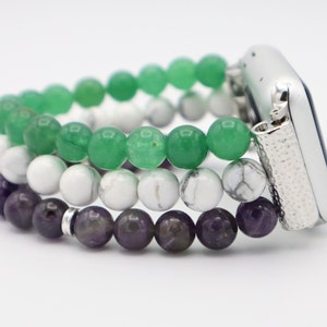 May include: A three-strand beaded Apple Watch band with green, white, and purple beads. The band is made of natural stones and is designed to fit a standard Apple Watch.