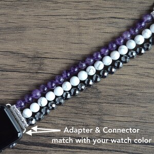 May include: A beaded Apple Watch band with amethyst, white howlite, and black hematite beads. The adapter and connector match the watch color.