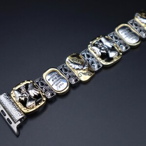 May include: A silver and gold watch band with an angel design and the inscription "angels are watching over you".