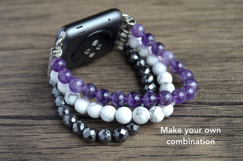 May include: A watch band made of three strands of beads. The top strand is amethyst, the middle strand is white howlite, and the bottom strand is black hematite. "Make your own combination" is written in the bottom right corner of the image.