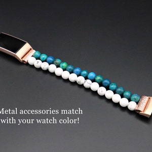 May include: A rose gold metal watch band with a white and blue gemstone design. The band is made of small, round beads and has a metal clasp.