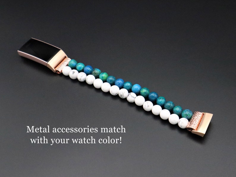 May include: A rose gold metal watch band with a white and blue gemstone design. The band is made of small, round beads and has a metal clasp.