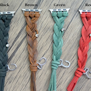 May include: Four braided leather Apple Watch bands in black, brown, green, and red. Each band has a silver clasp and a tassel.