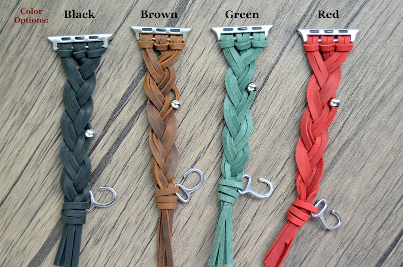 May include: Four braided leather Apple Watch bands in black, brown, green, and red. Each band has a silver clasp and a tassel.