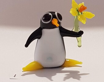 Glass Penguin holding a flower