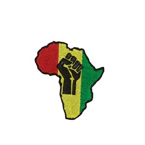 May include: An embroidered patch in the shape of the African continent, featuring vertical stripes of red, yellow, and green. A black raised fist silhouette is centred over the yellow and green sections, all outlined with a thick black border.