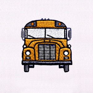 May include: Embroidered patch of a yellow school bus with black and gray details. The bus has a black grill, headlights, and windshield wipers. The bus is centered on a white background.