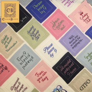 May include: A selection of embroidered square cocktail napkins in various colours, each with a different phrase. Napkins include phrases like "Please leave by 9" and "Drinks are on the house". The "Conary & Blanche" logo is in the upper left.