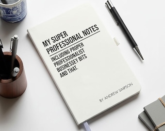 May include: A white notebook with the text "MY SUPER PROFESSIONAL NOTES" and "INCLUDING PROPER PROFESSIONALIST BUSINESSEY BITS AND THAT." A pen, a mug of coffee, and a wooden pen holder are also on the white surface.