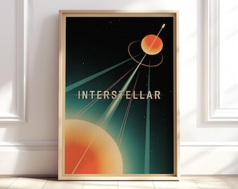May include: A framed art print featuring a retro-style space scene. The artwork showcases a large orange planet, a smaller planet with rings, and the word "INTERSTELLAR" in gold lettering against a dark background with teal and white rays.
