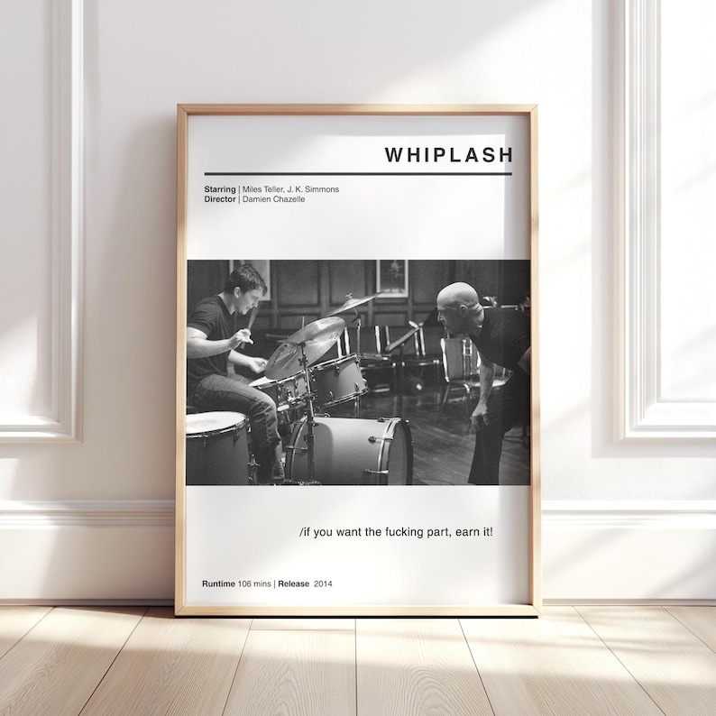 May include: A framed black and white movie poster for "Whiplash" with a wooden frame. The poster features a drummer and a man looking on. Text includes the movie title, credits, and the quote "/if you want the fucking part, earn it!"