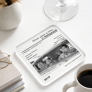 May include: Square coaster with a black and white image from the film "Once Upon a Time in Hollywood." The coaster displays the film's title, cast, and the year 2019. A quote from the film is also visible.