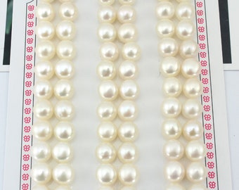 May include: Three rows of white pearls, each row containing 10 pearls, arranged on a white card with a pink border.
