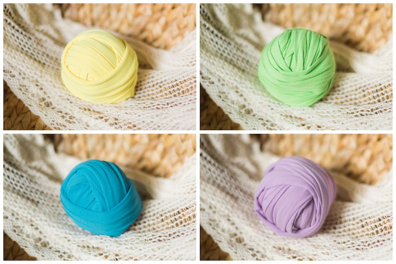 May include: Four balls of fabric in different colors: yellow, green, blue, and purple. The balls are made of soft, stretchy fabric and are perfect for newborn photography props.