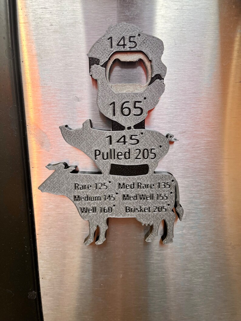 May include: A metal pig-shaped bottle opener with a thermometer on the side. The thermometer has markings for different temperatures, including rare, medium rare, medium, medium well, well, and brisket. The thermometer also has a built-in bottle opener.
