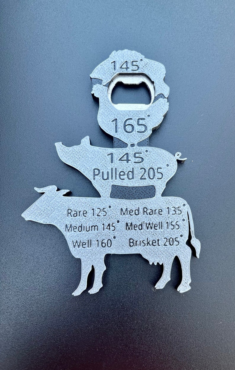 May include: A silver metal meat thermometer shaped like a cow, pig, and a bottle opener. The thermometer has different temperatures for different types of meat, including rare, medium rare, medium, medium well, well, pulled pork, and brisket.