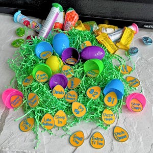 May include: A collection of colorful plastic Easter eggs filled with small yellow circles with various activities written on them, such as "Game Night", "Pick Dessert", "Sleep In", "Late Bedtime", "Pizza Night", "Skip Chore", "Park Trip", "Small Toy", "Extra TV Time", and "Pick Dinner".