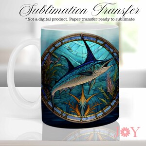 May include: White ceramic mug featuring a blue marlin design within a stained-glass style frame. The artwork includes aquatic plants and a blue and gold border. The mug has a white handle and the text "Sublimation Transfer".